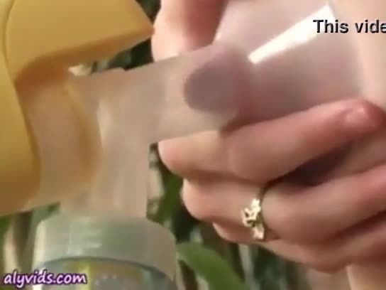 Hand expressing milk from huge ebony tits